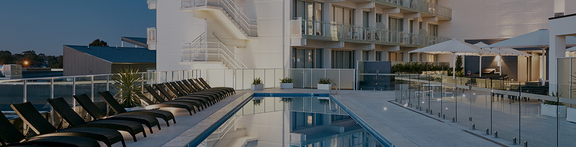 White building with a blue lap pool